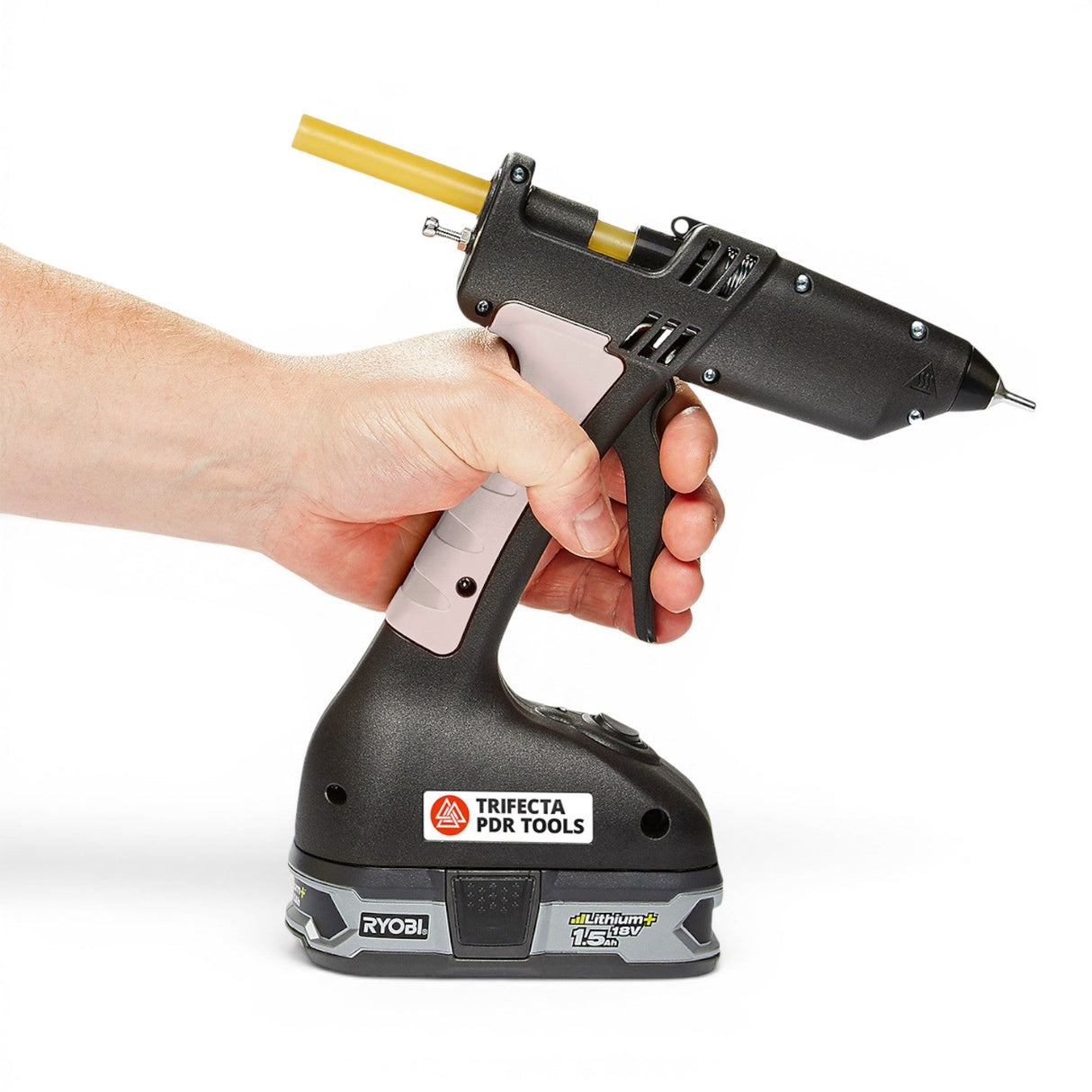 Anson PDR Trifecta dual temperature glue gun held by a hand, with a yellow glue stick inserted. Features a Ryobi 18V battery.