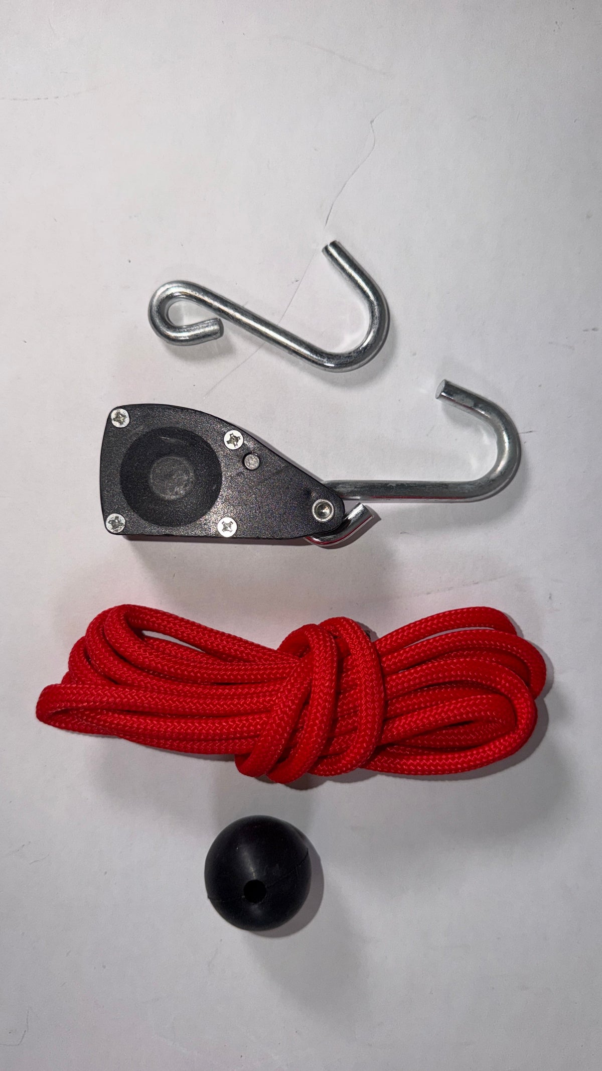 Anson PDR 1/4 inch rope ratchet with red paracord, black pulley mechanism, metal hooks, and a black stopper ball.